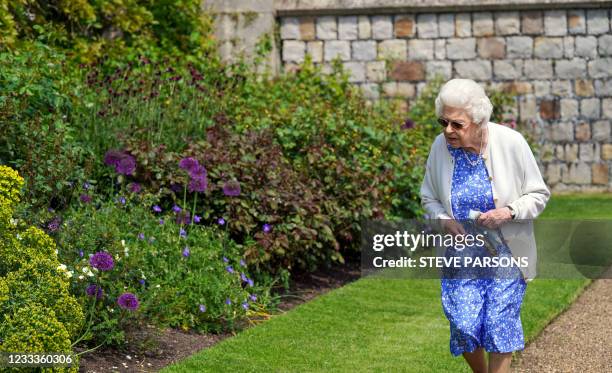 Britain's Queen Elizabeth II views a flower bed in the grounds of Windsor Castle, after she was presented with a Duke of Edinburgh rose, named in...