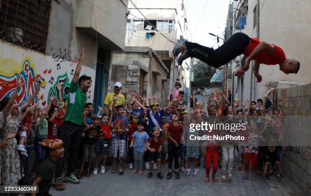 Palestinian members of Gaza's Bar Woolf sports team perform during a sports show as an entertainment for children at the Beach refugee camp, in Gaza...