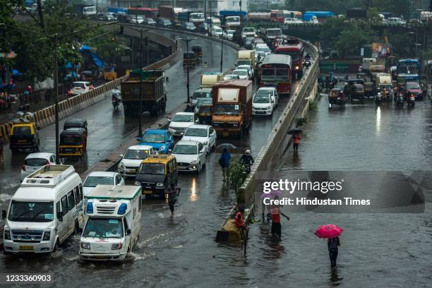 Vehicles wade through waterlogged road due to heavy rain at Santacruz-Chembur Link Road on June 9, 2021 in Mumbai, India. The south-west monsoon...