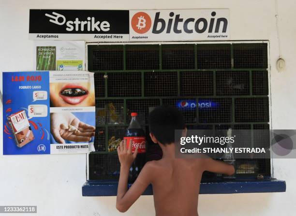 Man buys in a store that accepts bitcoins in El zonte, 56 km south east from San Salvador, on June 09, 2021. - Bitcoin is to become legal tender in...