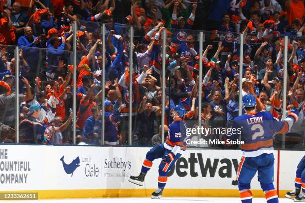 Brock Nelson of the New York Islanders celebrates after scoring a goal against the Boston Bruins as fans cheer during the second period in Game Six...