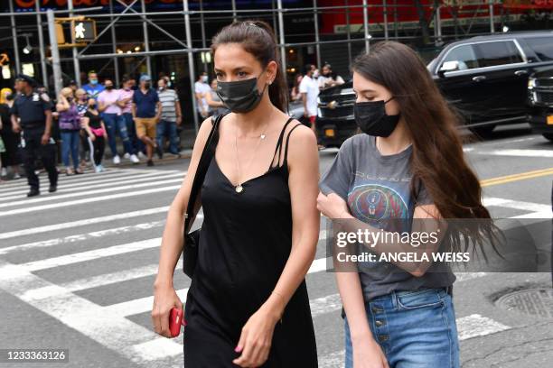 Actress Katie Holmes and daughter Suri Cruise arrive the opening night premiere of "In The Heights" during the Tribeca Festival at the United Palace...