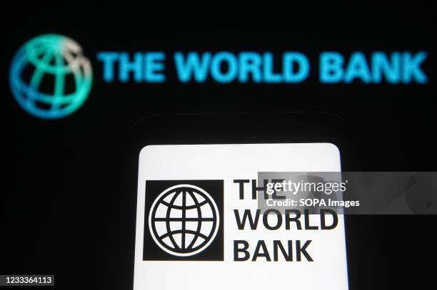 In this illustration, The World Bank logo seen displayed on a smartphone and a pc screen.