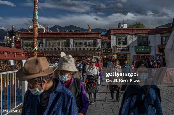 Tibetan Buddhists walk the kora in front the Jokhang Temple, a UNESCO heritage site, on June 1, 2021 in Lhasa, Tibet Autonomous Region, China. Travel...