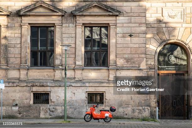 An electric scooter is pictured in front of an old house front on June 09, 2021 in Berlin, Germany.