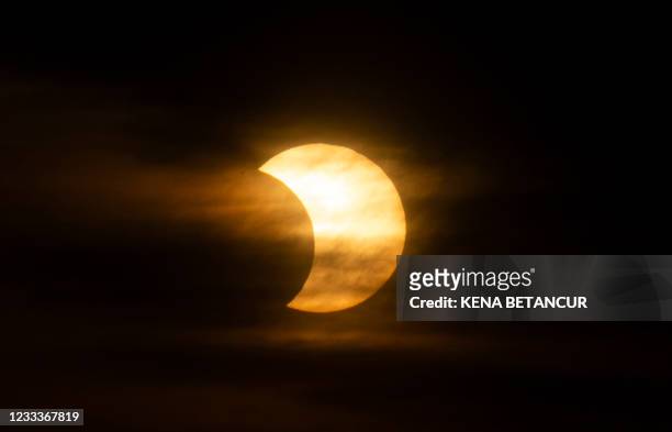Eclipsed sun rises over New York City on June 10, 2021 seen from Jersey City, New Jersey. - Northeast states in the U.S. Will see a rare eclipsed...