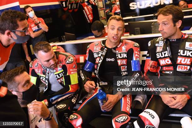 Suzuki GSXR 1000 Formula EWC N°1 French rider Gregg Black talks next to his teammate Belgian rider Xavier Simeon after the first free practice...