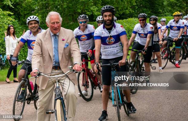Britain's Prince Charles, Prince of Wales cycles on a bicycle as he joins members of the British Asian Trust for a short distance as they kick-start...
