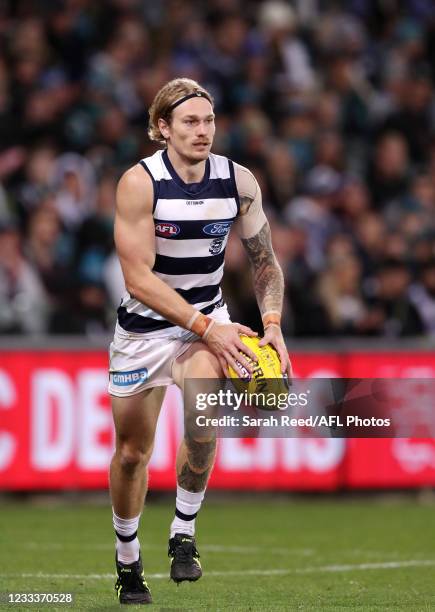 Tom Stewart of the Cats kicks the ball during the 2021 AFL Round 13 match between the Port Adelaide Power and the Geelong Cats at Adelaide Oval on...