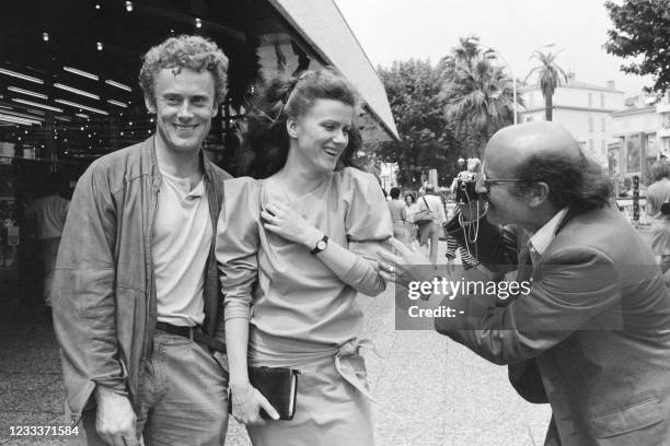 German filmmaker Volker Schlöndorff takes a picture of Polish actors Barbara Sukowa and Daniel Olbrychski on May 16, 1986 during the Cannes Film...