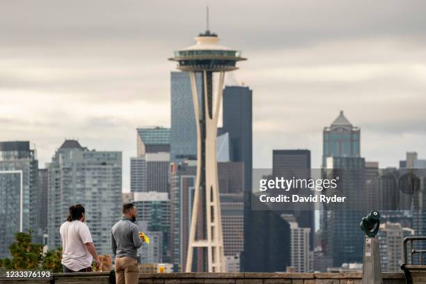 People take in a view of the skyline as Seattle has become the first major city to reach a 70 percent COVID-19 vaccination rate on June 10, 2021 in...