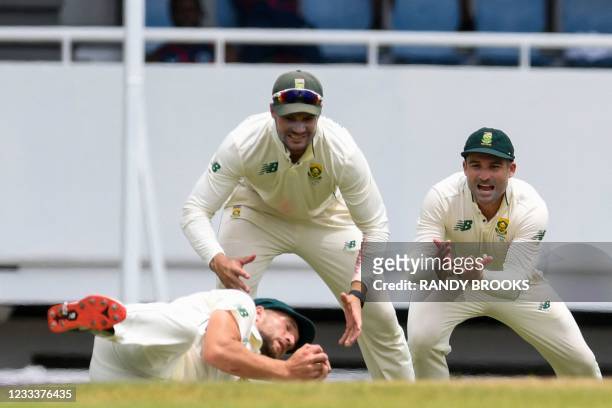 Dean Elgar and Aiden Markram watch as Wiaan Mulder of South Africa takes the catch to dismiss Joshua de Silva of West Indies during day 1 of the 1st...