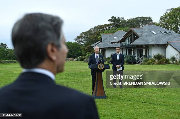 Secretary of State Antony Blinken listens as US President Joe Biden makes a speech on the Covid pandemic, while Pfizer CEO Albert Bourla stands...