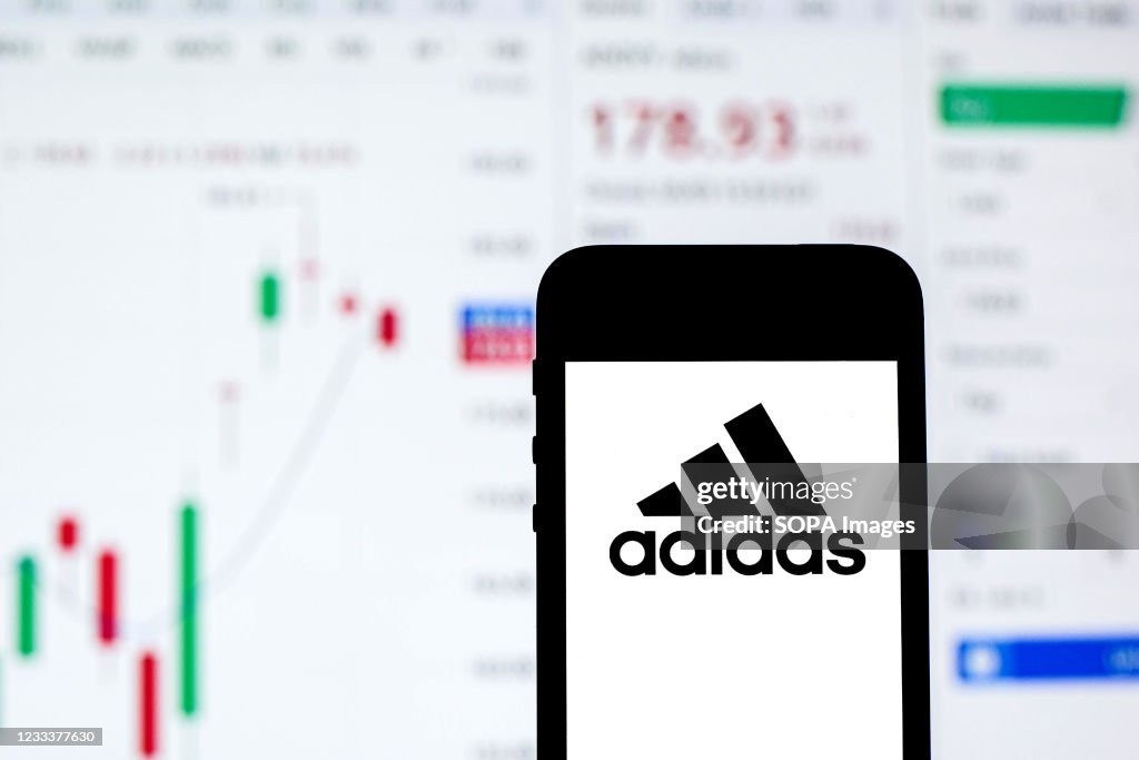 In this photo illustration an Adidas logo seen displayed on...