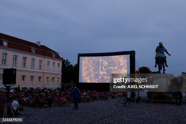 People attend the screening of "Philly D A" as part of the 'Berlinale Summer Special' film festival in Berlin on June 10, 2021. - Due to the...