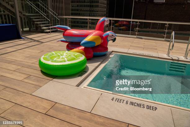 Inflatable floats on the rooftop pool at the Margaritaville Resort Times Square during the opening in New York, U.S., on Thursday, June 10, 2021. The...