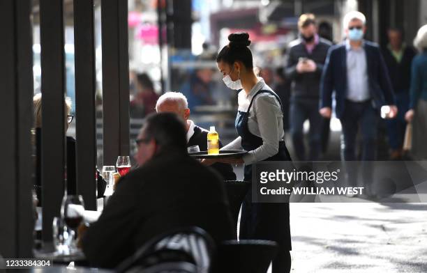 People dine out in Melbourne's Lygon Street cafe and restaurant strip on June 11 as the city eases restrictions after a two-week lockdown following a...