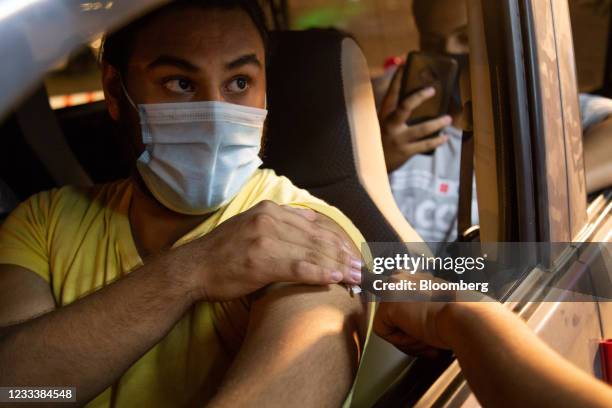 Person receives a Covid-19 vaccine at a drive-through vaccination center set up at the Gaddafi Stadium in Lahore, Pakistan, on Thursday, June 10,...