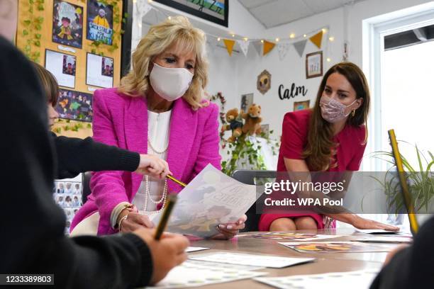 Catherine, Duchess of Cambridge and U.S. First Lady Dr Jill Biden, looking at a picture of the cover of Greta and the Giants, in the schools...