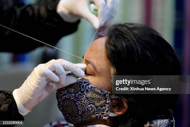 Beautician serves a customer after the relaxation of COVID-19 lockdown in Bhopal, the capital city of India's Madhya Pradesh state, June 10, 2021.