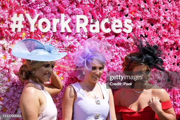 Racegoers pose for photographs at York Racecourse on June 11, 2021 in York, England.