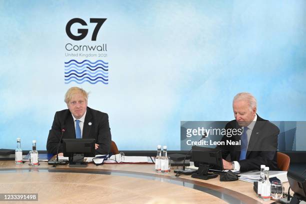 British Prime Minister Boris Johnson and US President Joe Biden sit around the table at the top of the G7 meeting in Carbis Bay, on June 11, 2021 in...