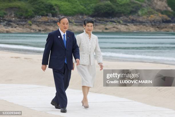 Japan's Prime Minister Yoshihide Suga and his wife Marika Suga arrive for the welcome prior to the start of the G7 summit in Carbis Bay, Cornwall on...