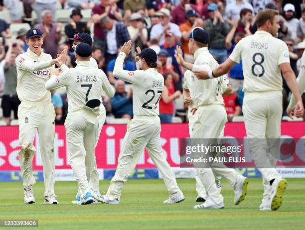 England's Zak Crawley celebrates with teammates after catching out New Zealand's Devon Conway for 80 runs during the second day of the second Test...