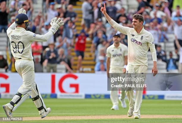 England's Dan Lawrence celebrates taking the wicket of New Zealand's Will Young with England's James Bracey during the second day of the second Test...