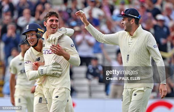 England's Dan Lawrence celebrates taking the wicket of New Zealand's Will Young with England's James Bracey during the second day of the second Test...