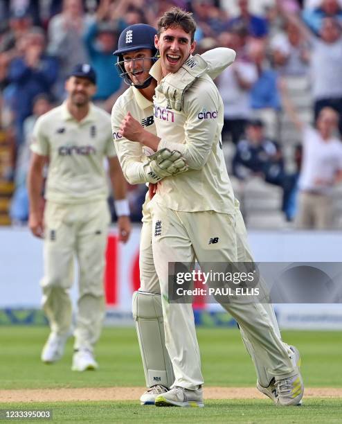 England's Dan Lawrence celebrates taking the wicket of New Zealand's Will Young with England's James Bracey during the second day of the second Test...