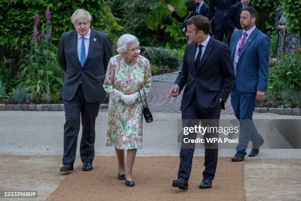 French President Emmanuel Macron, Queen Elizabeth II, British Prime Minister Boris Johnson and United States President Joe Biden arrive at a drinks...