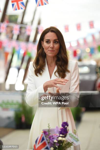 Catherine, Duchess of Cambridge, speaks as she attends an event with Queen Elizabeth II in celebration of The Big Lunch initiative at The Eden...