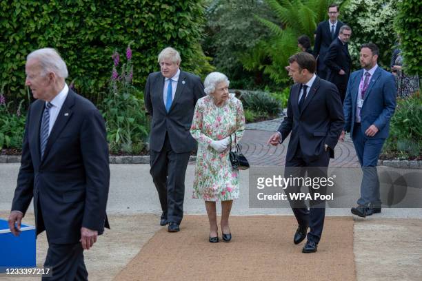 French President Emmanuel Macron, Queen Elizabeth II, British Prime Minister Boris Johnson and United States President Joe Biden arrive at a drinks...