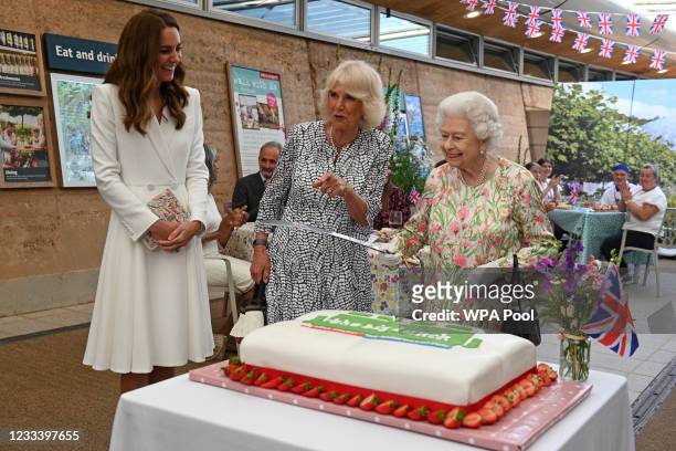 Queen Elizabeth II considers cutting a cake with a sword, lent to her by The Lord-Lieutenant of Cornwall, Edward Bolitho, to celebrate of The Big...