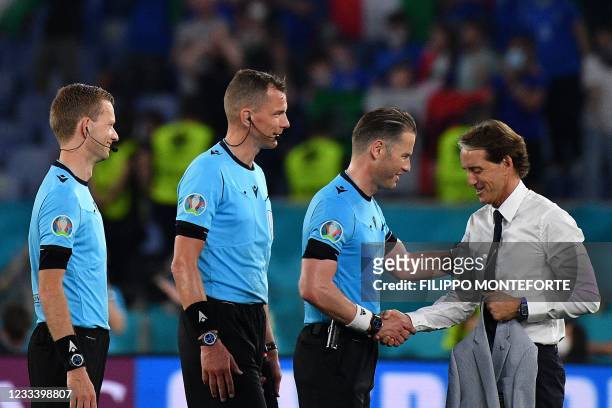 Italy's coach Roberto Mancini shakes hands with Dutch referee Danny Makkelie at the end of the UEFA EURO 2020 Group A football match between Turkey...