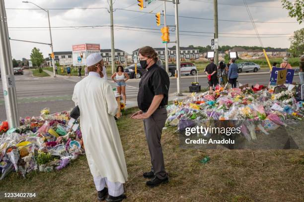 Religious leaders talk at the scene where a Muslim family was killed in a vehicle attack in London, Ontario, Canada, on Friday, June 11 before a...