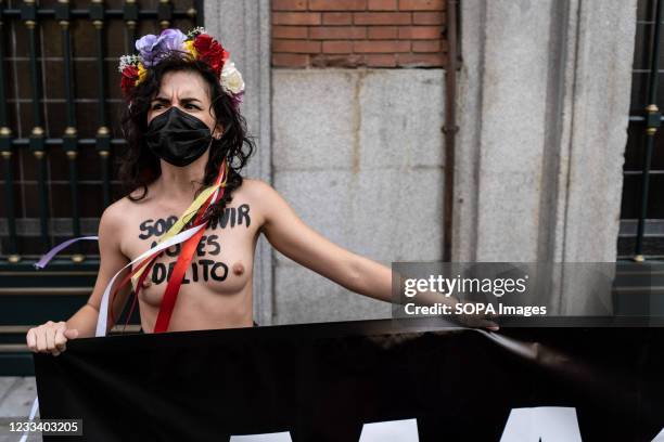 Protester stands in front of the Justice Ministry with inscriptions in her chest, during the demonstration. Motivated by the killings of three women...