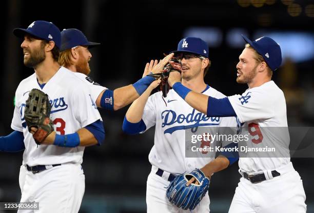 Gavin Lux of the Los Angeles Dodgers celebrate with Zach McKinstry and Justin Turner after defeating Texas Rangers, 12-1, at Dodger Stadium on June...