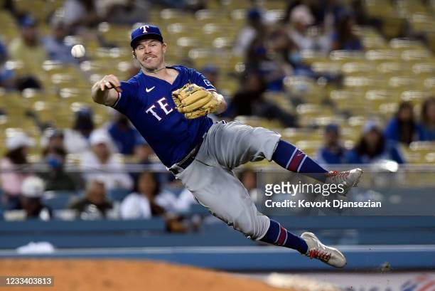 Brock Holt of the Texas Rangers attests to throw out AJ Pollock of the Los Angeles Dodgers during the eight inning at Dodger Stadium on June 11, 2021...