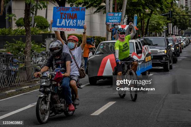 Filipinos take part in a motorcade as they mark Independence day with a protest against continued Chinese intrusions in Philippine waters, outside...