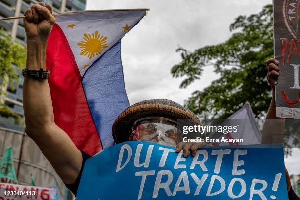 Filipinos march as they mark Independence day with a protest against continued Chinese intrusions in Philippine waters, outside the Chinese Embassy...