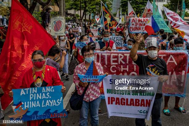 Filipinos march as they mark Independence day with a protest against continued Chinese intrusions in Philippine waters, outside the Chinese Embassy...