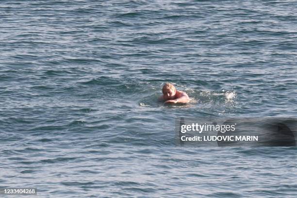 Britain's Prime Minister Boris Johnson swims at Carbis Bay, Cornwall during the G7 summit on June 12, 2021. - G7 leaders from Canada, France,...