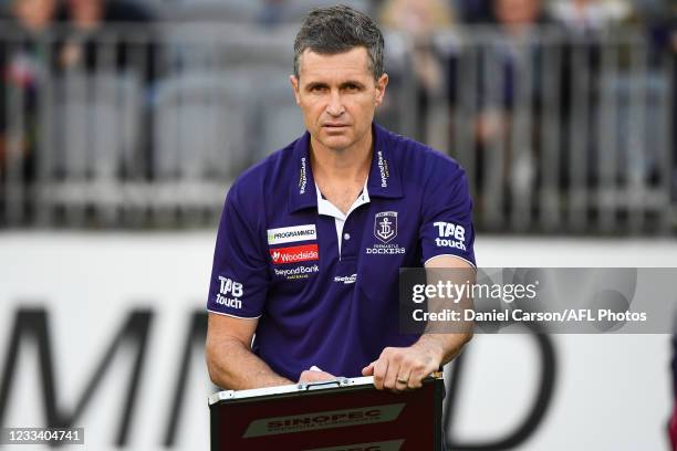 Justin Longmuir, Senior Coach of the Dockers draws on the team board at three quarter time during the 2021 AFL Round 13 match between the Fremantle...