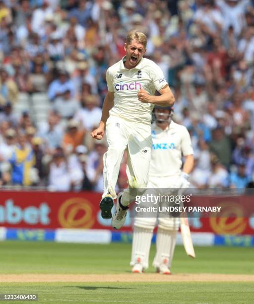 England's Olly Stone celebrates after taking the wicket of New Zealand batsman Ross Taylor on the third day of the second Test cricket match between...