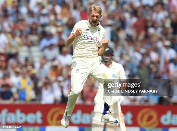 England's Olly Stone celebrates after taking the wicket of New Zealand batsman Ross Taylor on the third day of the second Test cricket match between...