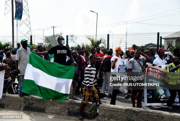 Protester holds his national flag during a demonstration at Ojota in Lagos on June 12 as Nigerian activists called for nationwide protests over what...