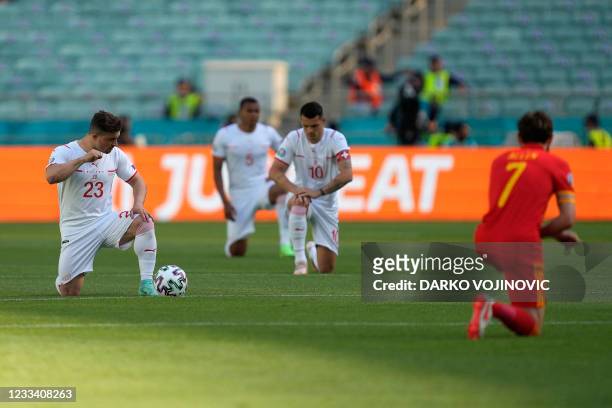 Switzerland's midfielder Xherdan Shaqiri, Switzerland's defender Manuel Akanji, Switzerland's midfielder Granit Xhaka and Wales' midfielder Joe Allen...