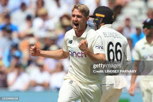 England's Olly Stone celebrates taking the wicket of New Zealand's Daryl Mitchell during play on the third day of the second Test cricket match...